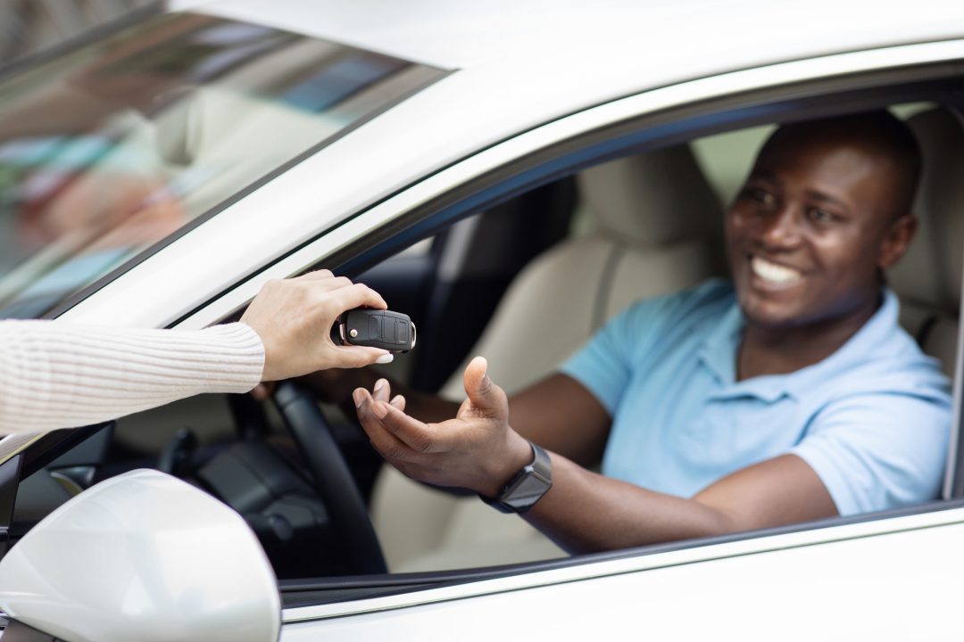 Driver receiving the keys to a rental car